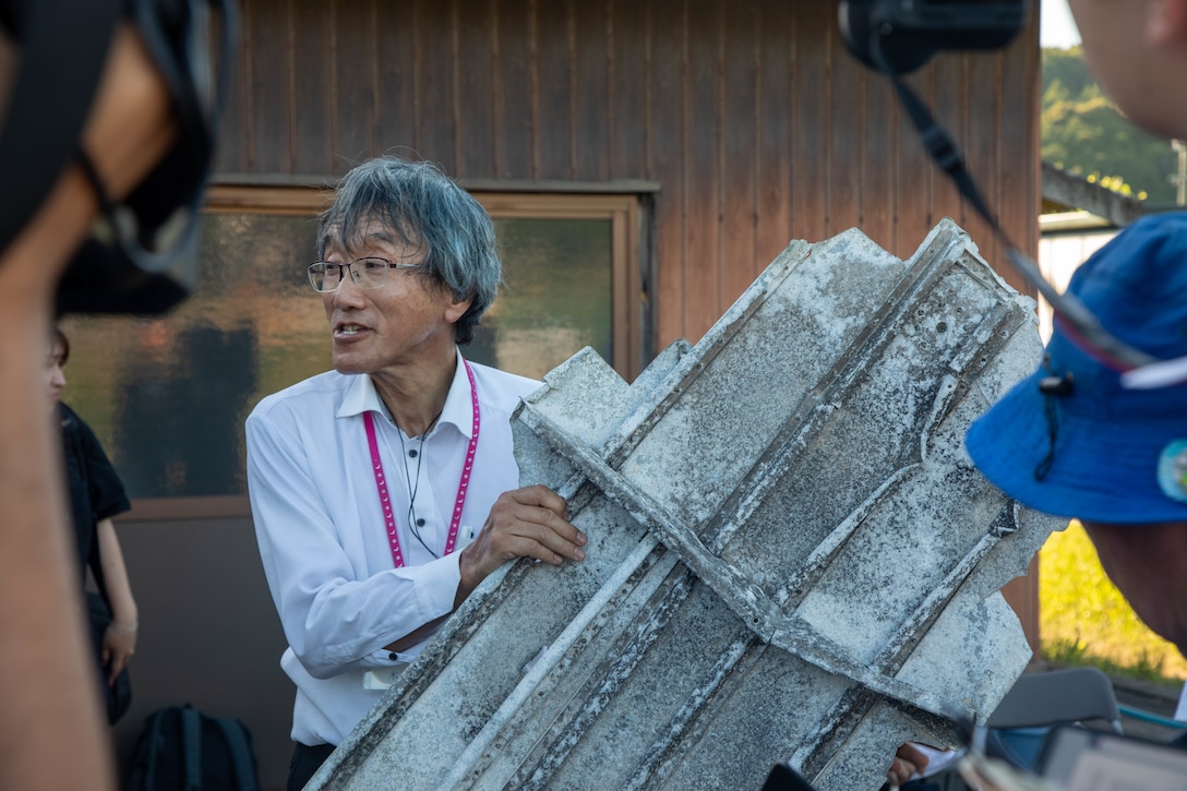 Shuzo Kinoshita, an event organizer, shows a piece of debris recovered from the B-24 Liberator aircraft “Lonesome Lady” during a memorial event in Yanai, Japan, July 28, 2025. Local residents came together to support the memorial in Yanai, Japan, paying tribute to American and Japanese lives lost during World War II. (U.S. Marine Corps photo by Lance Cpl. Micah Taylor)