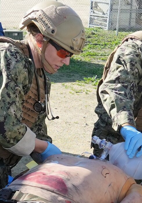 Lt. Cmdr. Rachael Robeck, physician assistant assigned to Expeditionary Resuscitative Surgical System (ERSS) 15, based out of Navy Medicine Readiness and Training Command (NMRTC) Camp Pendleton, provides simulated trauma care to a casualty during an ERSS training conducted by Naval Expeditionary Medicine Warfighter Development Center (NEMWDC) at Camp Pendleton, California, Dec. 16, 2025. The scenario replicates penetrating chest trauma and requires coordinated team-based care in a field environment. “Scenarios like this reinforce the importance of rapid assessment and decisive intervention when managing penetrating chest trauma in a field environment,” said Robeck. The ERSS 15 team is currently assigned to the Naval Strategic Health Alliance for Readiness and Performance (SHARP), a partnership with Penn Medicine that embeds active-duty Navy trauma personnel into Penn Presbyterian’s Level I trauma center. This initiative sustains combat casualty care skills and provides hands-on experience with complex civilian trauma.  (U.S. Navy photo by Petty Officer 1st Class Trevin Perry)