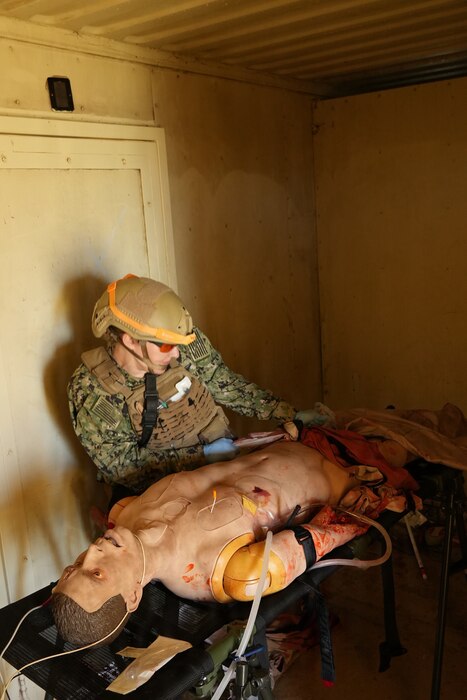 Lt. Cmdr. Rachael Robeck, physician assistant assigned to Expeditionary Resuscitative Surgical System (ERSS) 15, from Navy Medicine Readiness and Training Command (NMRTC) Camp Pendleton, provides simulated trauma care to a casualty during an ERSS training conducted by Naval Expeditionary Medicine Warfighter Development Center (NEMWDC) at Camp Pendleton, California, Dec. 16, 2025. The training scenario reinforces critical decision-making, patient assessment, and trauma management skills in a controlled but realistic environment. The ERSS 15 team is currently assigned to the Naval Strategic Health Alliance for Readiness and Performance (SHARP), a partnership with Penn Medicine that embeds active-duty Navy trauma personnel into Penn Presbyterian’s Level I trauma center. This initiative sustains combat casualty care skills and provides hands-on experience with complex civilian trauma. (U.S. Navy photo by Petty Officer 1st Class Trevin Perry)