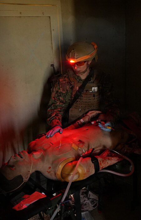 Lt. Cmdr. Rachael Robeck, physician assistant assigned to Expeditionary Resuscitative Surgical System (ERSS) 15, from Navy Medicine Readiness and Training Command (NMRTC) Camp Pendleton, provides simulated trauma care to a casualty during a realistic low-light medical training conducted by Naval Expeditionary Medicine Warfighter Development Center (NEMWDC) at Camp Pendleton, California, Dec. 16, 2025. The training emphasizes life-saving interventions under austere and confined conditions to prepare medical personnel for combat and expeditionary environments. The ERSS 15 team is currently assigned to the Naval Strategic Health Alliance for Readiness and Performance (SHARP), a partnership with Penn Medicine that embeds active-duty Navy trauma personnel into Penn Presbyterian’s Level I trauma center. This initiative sustains combat casualty care skills and provides hands-on experience with complex civilian trauma. (U.S. Navy photo by Petty Officer 1st Class Trevin Perry)