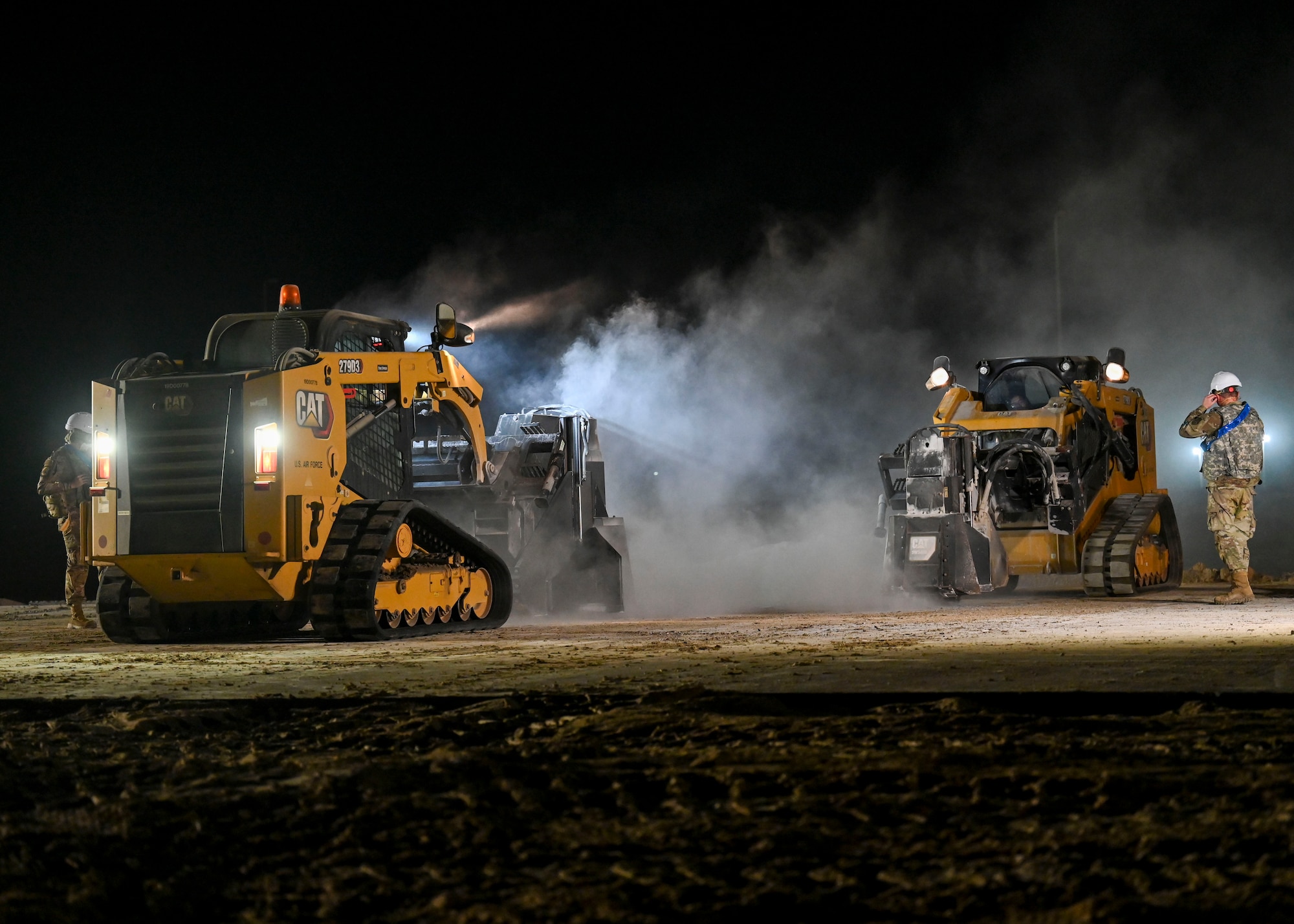 Machine operated saws cut into concrete.