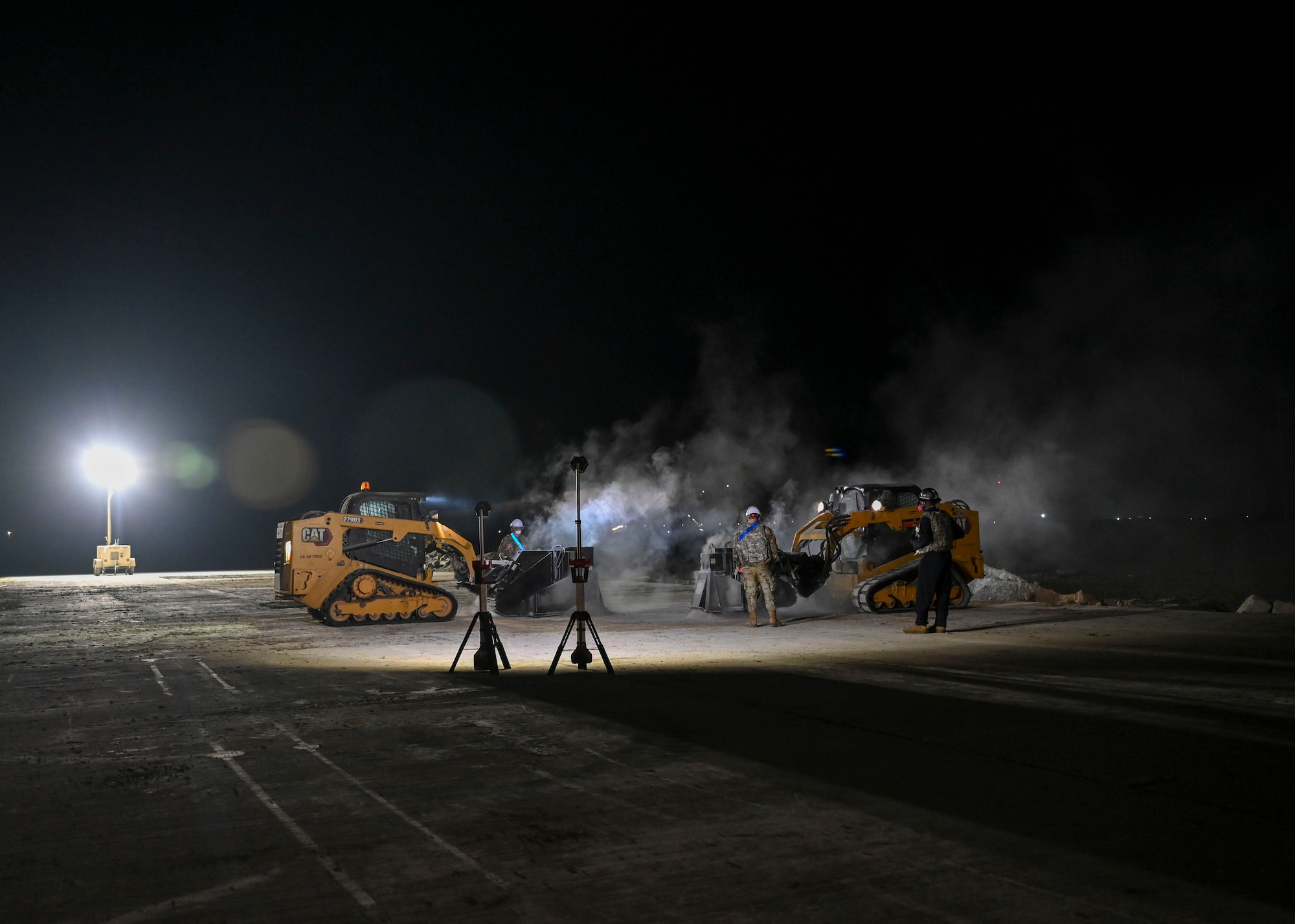 Large machine operated saws are used to cut into concrete.