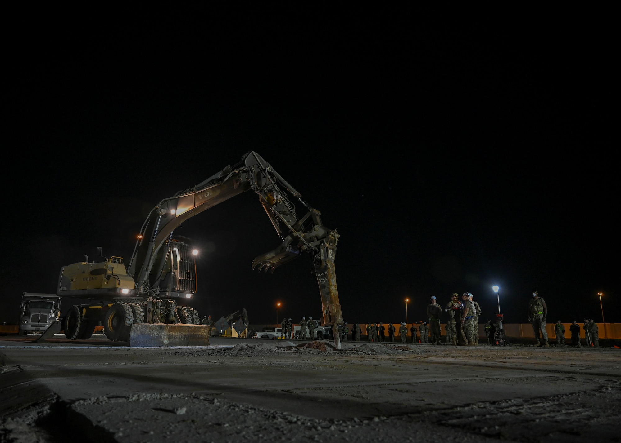 Heavy machinery is used to break apart concrete.
