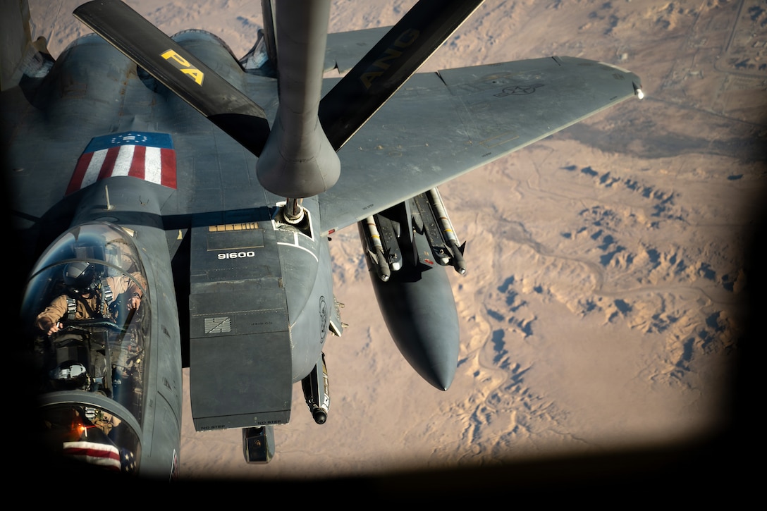 A U.S. Air Force F-15E Strike Eagle aircraft assigned to the 391st Expeditionary Fighter Squadron refuels from a KC-135 Stratotanker aircraft over the U.S. Central Command area of responsibility, Oct. 11, 2025. The KC-135 Stratotanker aircraft played a key role in integrating Air Mobility Command and Air Combat Command capabilities, ensuring U.S. aircraft can execute airpower missions across the CENTCOM AOR. (U.S. Air Force photo by Tech. Sgt. Nicholas Monteleone)