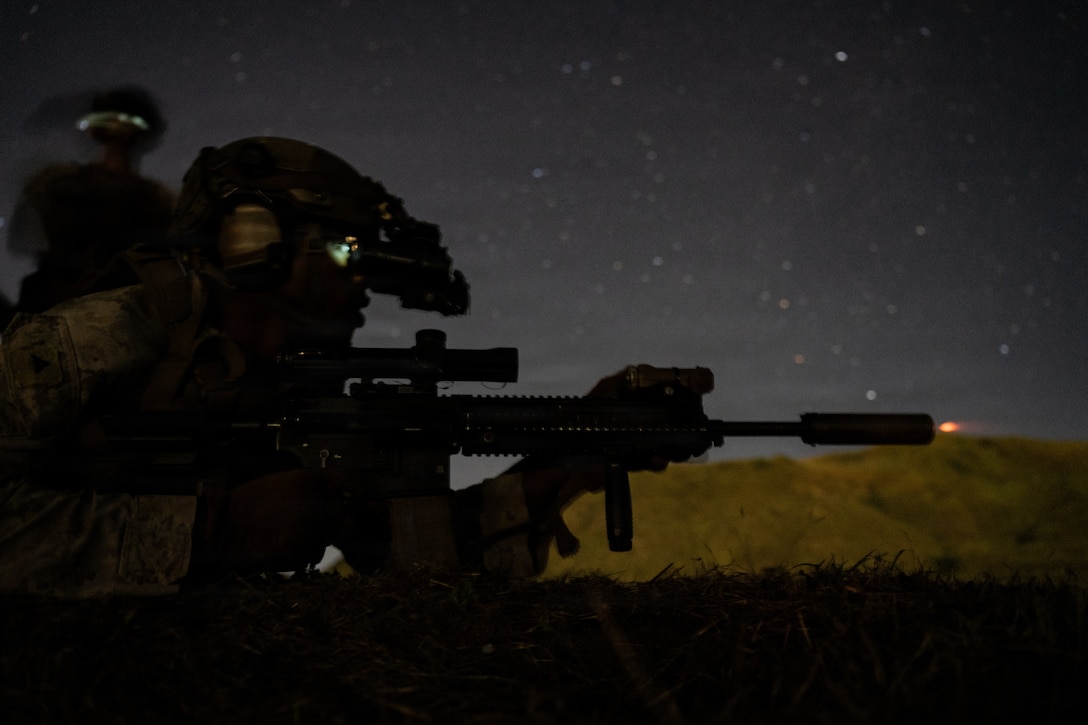 A U.S. Marine with Kilo Company, Battalion Landing Team 3/6, 22nd Marine Expeditionary Unit (Special Operations Capable), fires an M27 infantry automatic rifle during a night range at Camp Santiago, Puerto Rico, Jan. 7, 2026. U.S. military forces are deployed to the Caribbean in support of the U.S. Southern Command mission, Department of War-directed operations, and the president’s priorities to disrupt illicit drug trafficking and protect the homeland. (U.S. Marine Corps photo)
