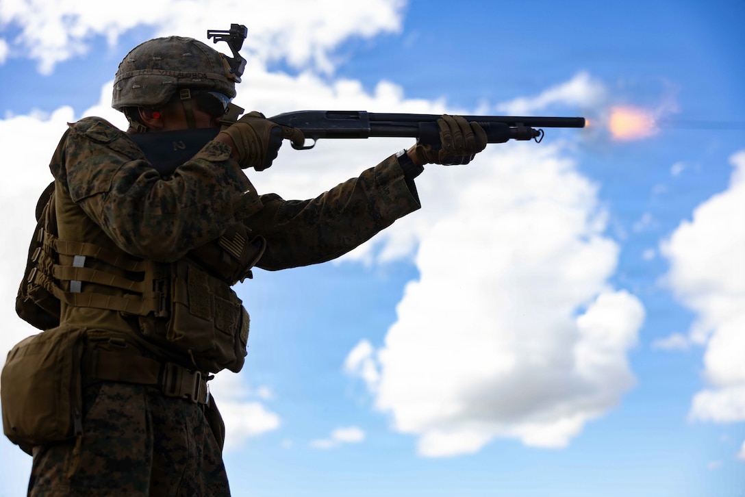 A U.S. Marine with Combat Logistics Battalion 26, 22nd Marine Expeditionary Unit (Special Operations Capable), fires a Mossberg 590A1 12-gauge shotgun during a shotgun range at Camp Santiago, Puerto Rico, Jan. 9, 2026. U.S. military forces are deployed to the Caribbean in support of the U.S. Southern Command mission, Department of War-directed operations, and the president’s priorities to disrupt illicit drug trafficking and protect the homeland. (U.S. Marine Corps photo)