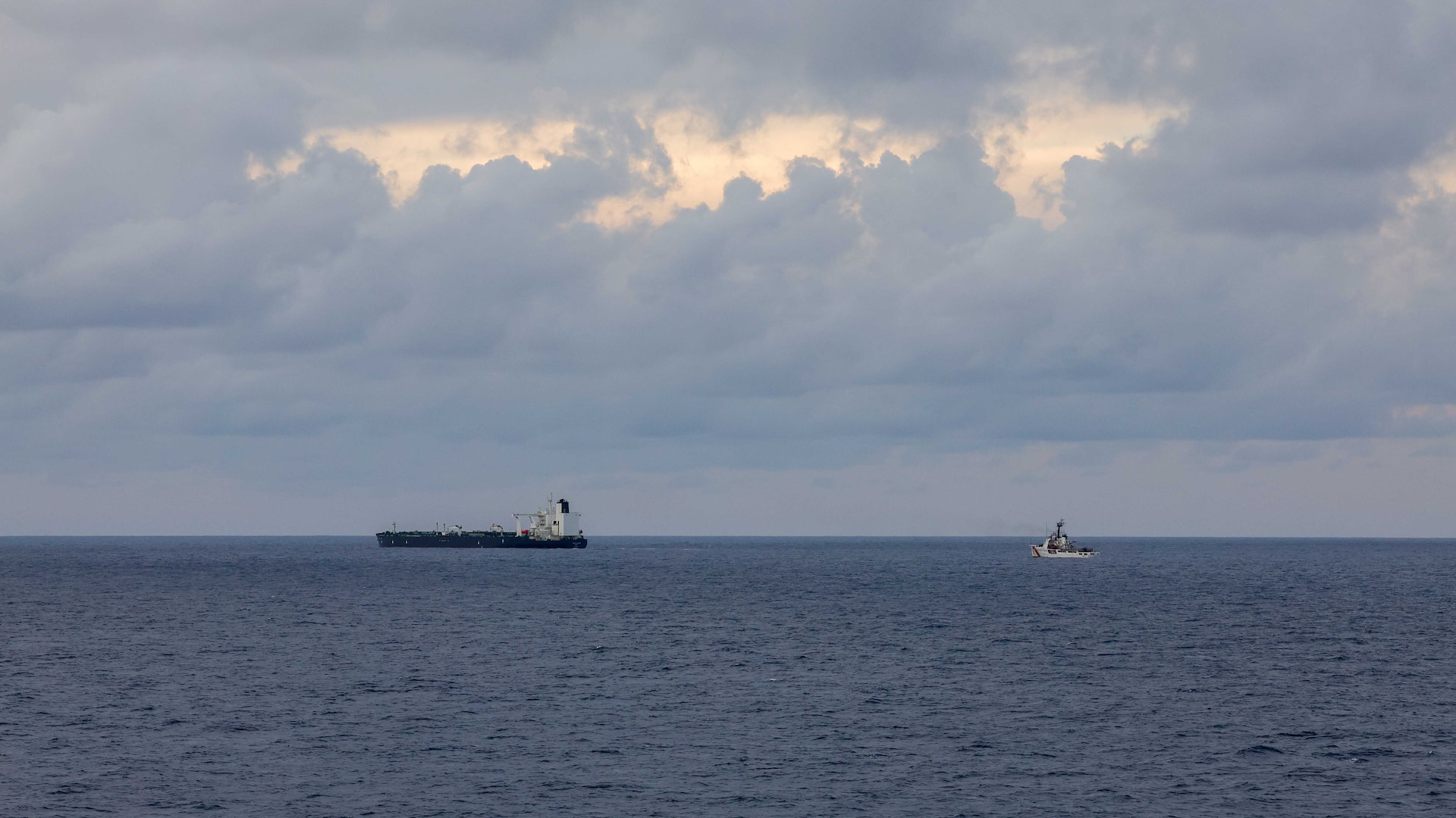 U.S. Coast Guard Cutter Vigilant (WMEC 617), right, sails in the Western Atlantic Ocean while escorting a motor tanker after a right of visit boarding, Jan. 7, 2026. Vigilant escorted the motor tanker, which was seized by a Coast Guard tactical boarding team with support from the Department of War, for operating as a vessel without nationality in the Caribbean Sea