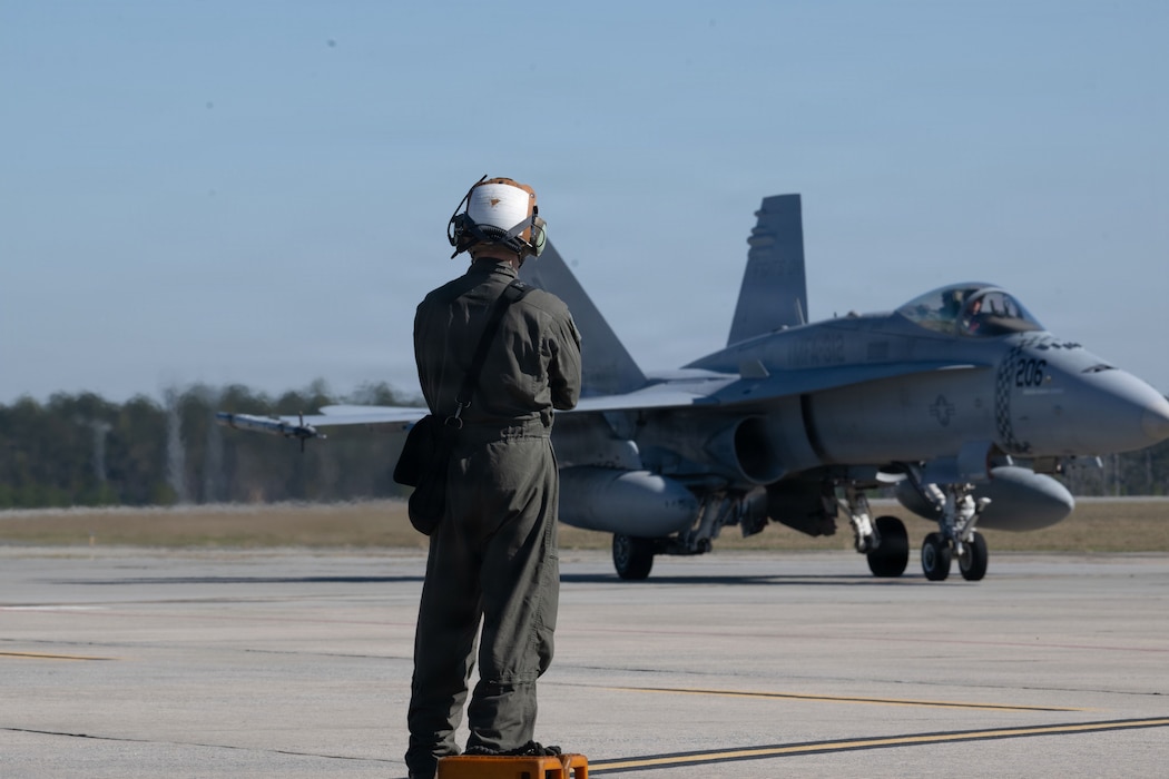 A U.S. Marine mechanic watches as a F/A-18C Hornet taxis in preparation for a Combat Search and Rescue Training Exercise sortie at Moody Air Force Base, Georgia Jan. 13, 2026. CSARTE 26-1 emphasized joint planning and execution of flight operations supporting personnel recovery missions. (U.S. Air Force photo by Senior Airman Iain Stanley)