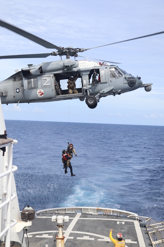 U.S. Coast Guard crewmembers transfer from the Coast Guard Cutter Vigilant (WMEC 617) to a motor tanker by a helicopter crew assigned to U.S. Navy Helicopter Sea Combat Squadron 9 in the Atlantic Ocean, Jan. 7, 2026. Vigilant escorted the tanker, which was seized by a joint Coast Guard and Department of War team for conducting illicit activities in the Caribbean Sea.
