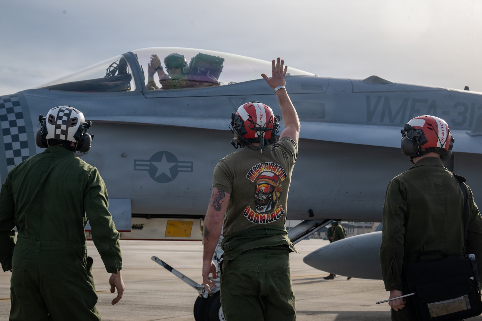 U.S. Marine Corps airframes mechanics assigned to Marine Fighter Attack Squadron 312 signal an F/A-18C Hornet pilot during Combat Search and Rescue Training Exercise 26-1 at Moody Air Force Base, Georgia Jan. 12, 2026. The joint exercise enhanced aircrew readiness by rehearsing coordinated flight operations in support of recovery missions. (U.S. Air Force photo by Senior Airman Iain Stanley)