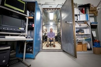 Matthew Wolford, Ph.D., U.S. Naval Research Laboratory (NRL) research chemist, poses for a photo in the Electra shield room in Washington, D.C., Jan. 8, 2026. Scientists at NRL use the shield room to control operation and diagnostic outputs of the Electra laser facility. (U.S. Navy photo by Sarah Peterson)