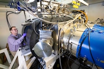 research chemist, adjusts a photodiode diagnostic on an argon fluoride laser in Washington, D.C., Jan. 8, 2026. Wolford uses the photodiode to measure the intensity of the laser and determine its efficiency for fusion energy applications. (U.S. Navy photo by Sarah Peterson)