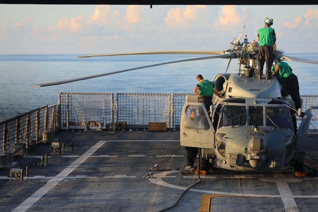 Sailors doing Helicopter maintenance.