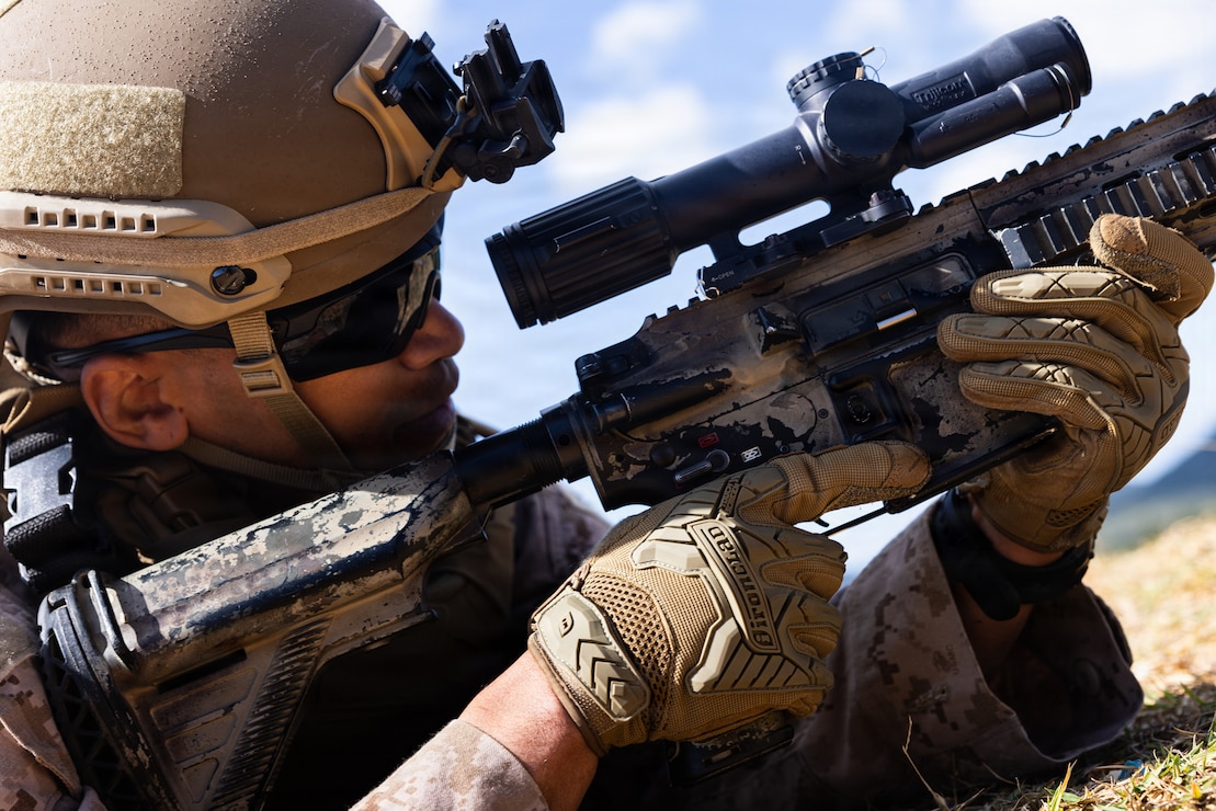 U.S. Marine Corps Sgt. Justin Reid, a rifleman with 12th Littoral Combat Team, 12th Marine Littoral Regiment, 3rd Marine Division, sights in with an M27 infantry automatic rifle during a squad attack dry-fire range as part of a squad competition on Camp Hansen, Okinawa.