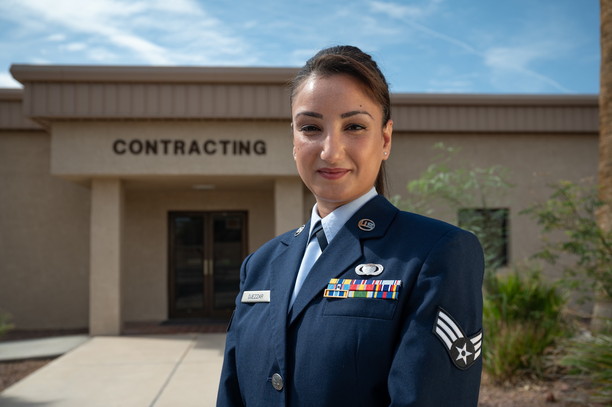 U.S. Air Force Senior Airman Amal Djezzar, 99th Contracting Squadron contract specialist stands outside the Contracting Squadron building at Nellis Air Force Base, Nevada, Aug. 22, 2025