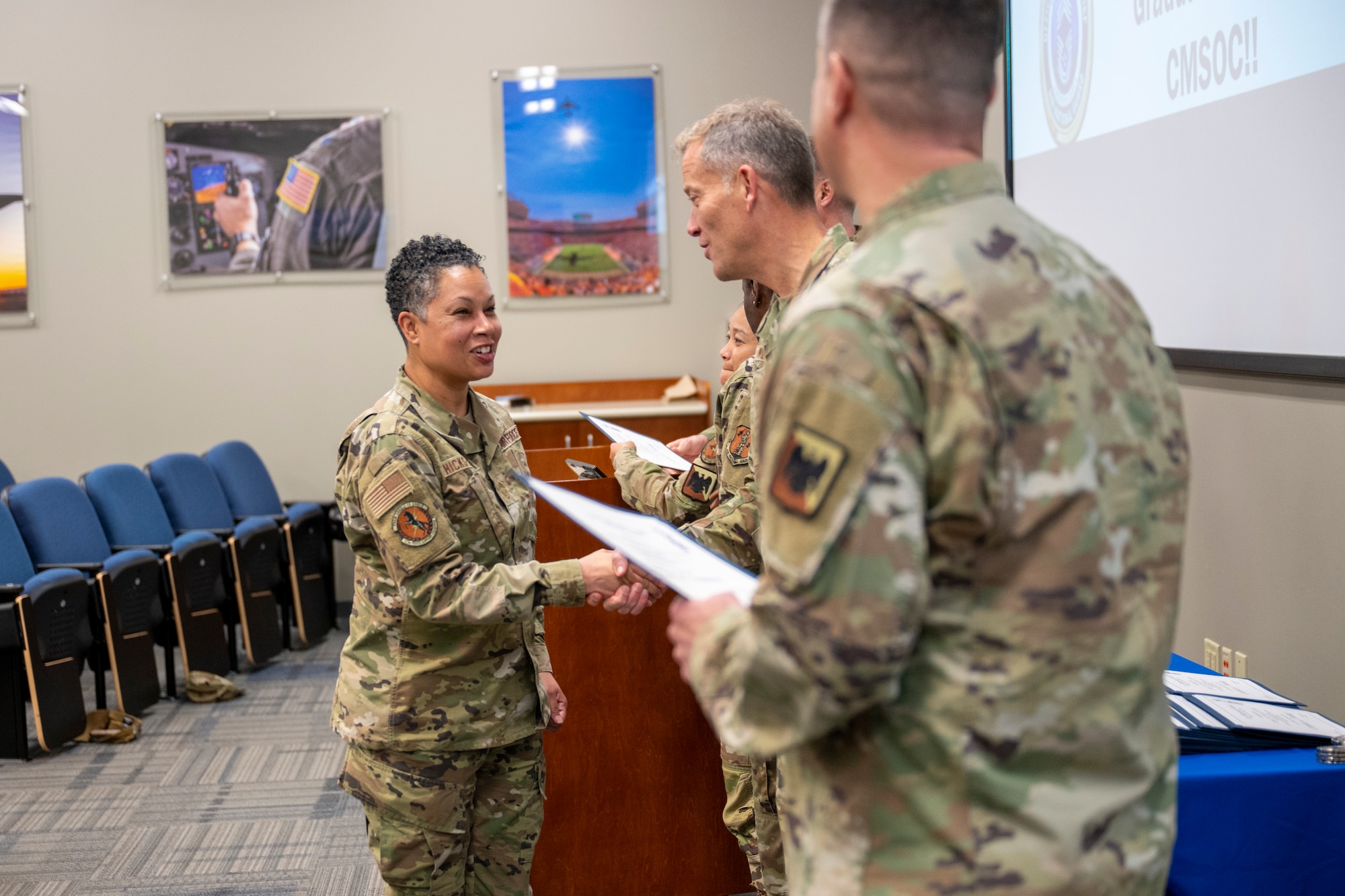 U.S. Air Force Chief Master Sgt. Karen Hicks-Fulton, left, accepts congratulations from Chief Master Sgt. Trenton Williams, command chief, 118th Wing, Tennessee National Guard, during a graduation of the Chief Master Sergeant Orientation Course (CMSOC), Jan. 9, 2026, at McGhee Tyson Air National Guard Base, Tennessee. The I.G. Brown Training and Education Center hosted the CMSOC, which provides newly selected chief master sergeants with advanced leadership education and a strategic-level perspective.  (U.S. Air National Guard photo by Master Sgt. Teri Eicher)