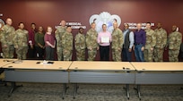 Wally Edwards, center, safety manager for U.S. Army Medical Logistics Command, presents the Army’s Safety Excellence Streamer award for the brigade level to team members at AMLC headquarters Jan. 7, 2026.