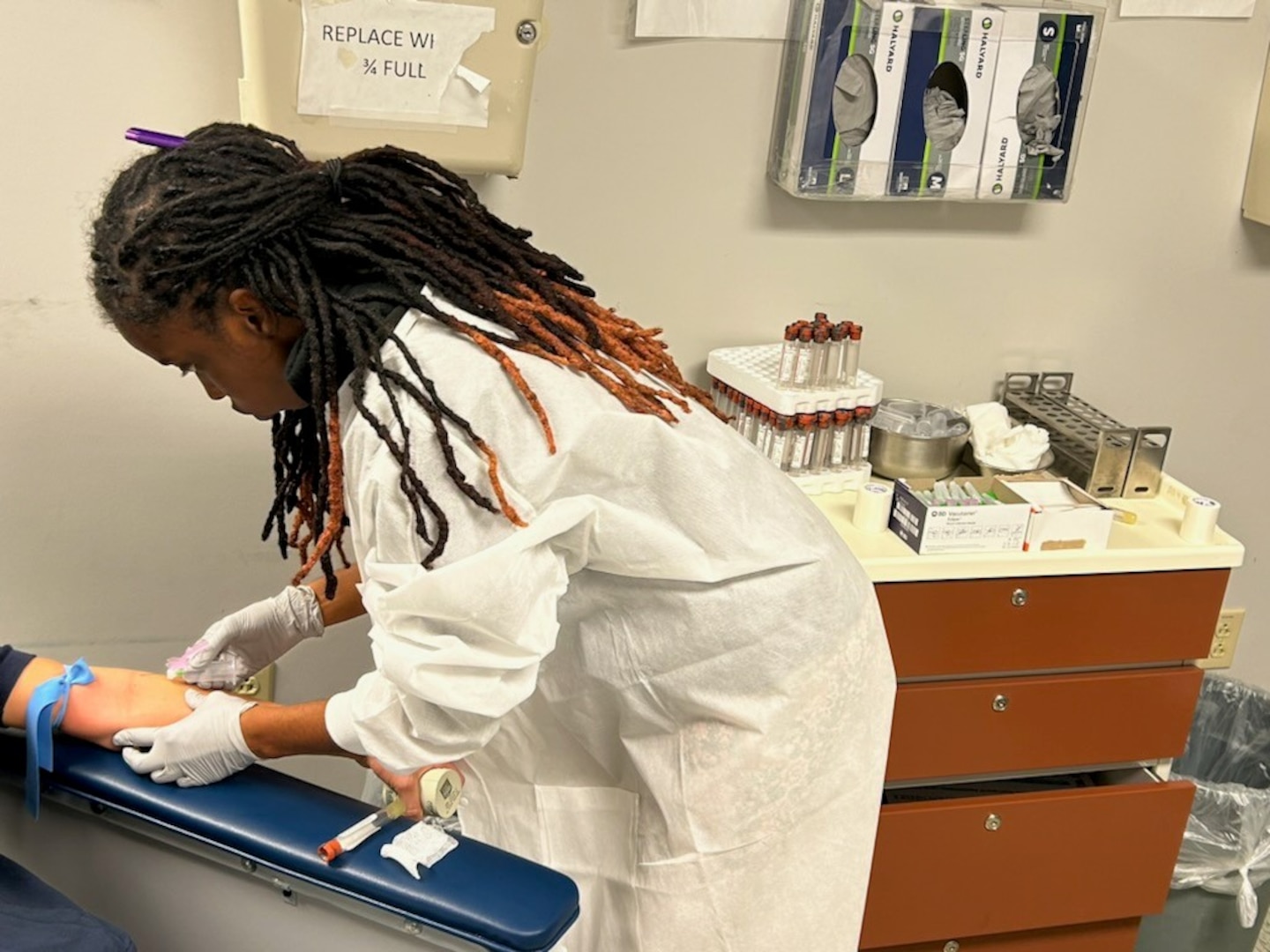 Gabrielle Vega, medical assistant extern at Boston MEPS, conducts a blood draw on an applicant. USMEPCOM introduced a new medical externship initiative designed to assist with collecting vitals, drawing blood and urine samples and conducting vision and audio screenings.