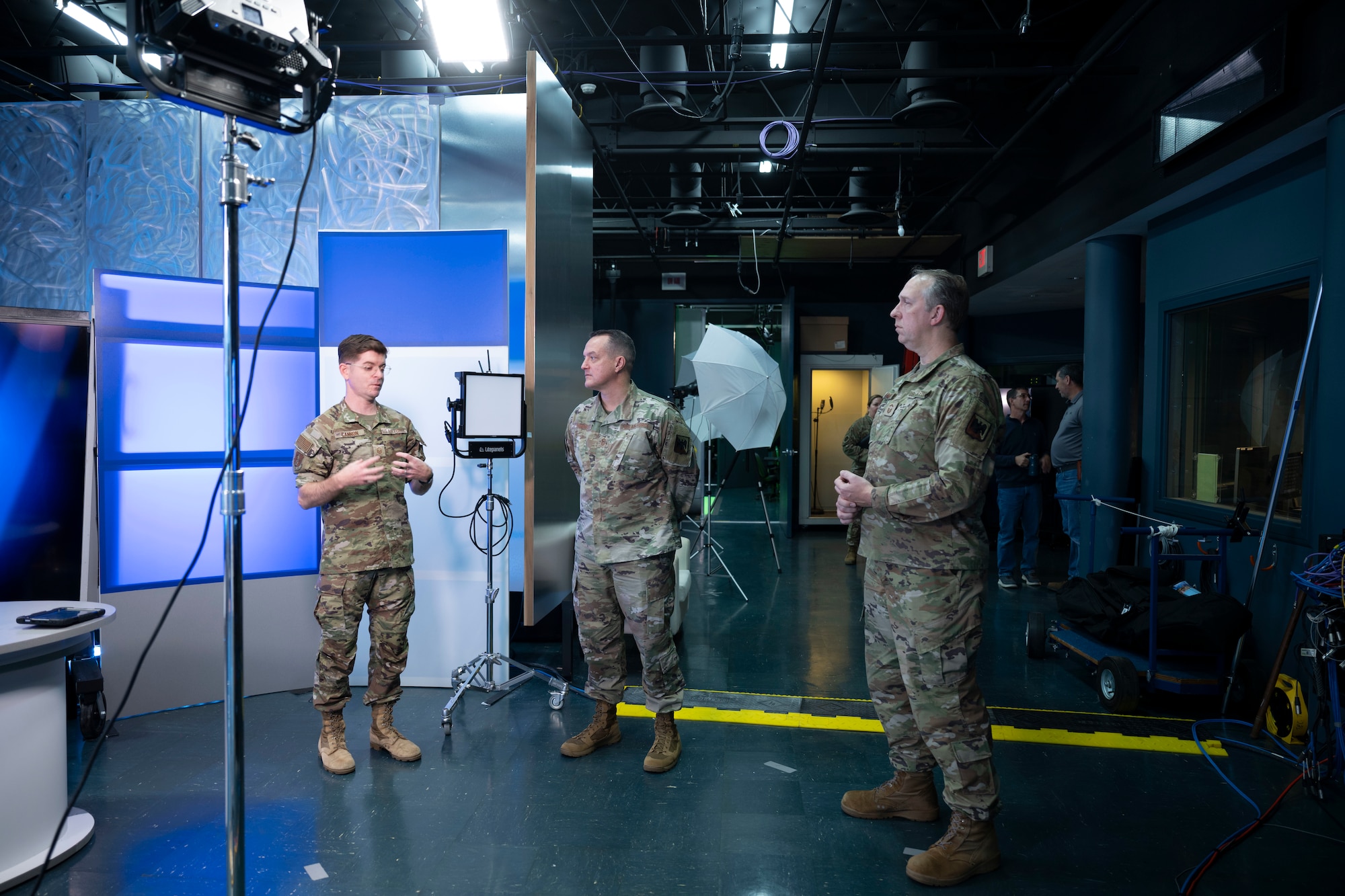 U.S. Air Force Master Sgt. Treven Cannon, left, briefs Chief Master Sgt. Josh Moore, center, command chief, Air National Guard, about the capabilities of the I.G. Brown Training and Education Center’s (TEC), TEC University (TEC-U) production studio on Jan. 8, 2026, at McGhee Tyson Air National Guard Base, Tennessee. TEC-U is home to the ANG’s premier production studio, enabling increased capabilities for education and comprehensive audio-visual solutions to the Total Force. (U.S. Air National Guard photo by Master Sgt. Regina Young)
