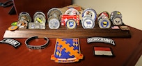 Some of the many coins and badges Command Chief Master Sgt. Christopher Mertz has received during his decades of military service.