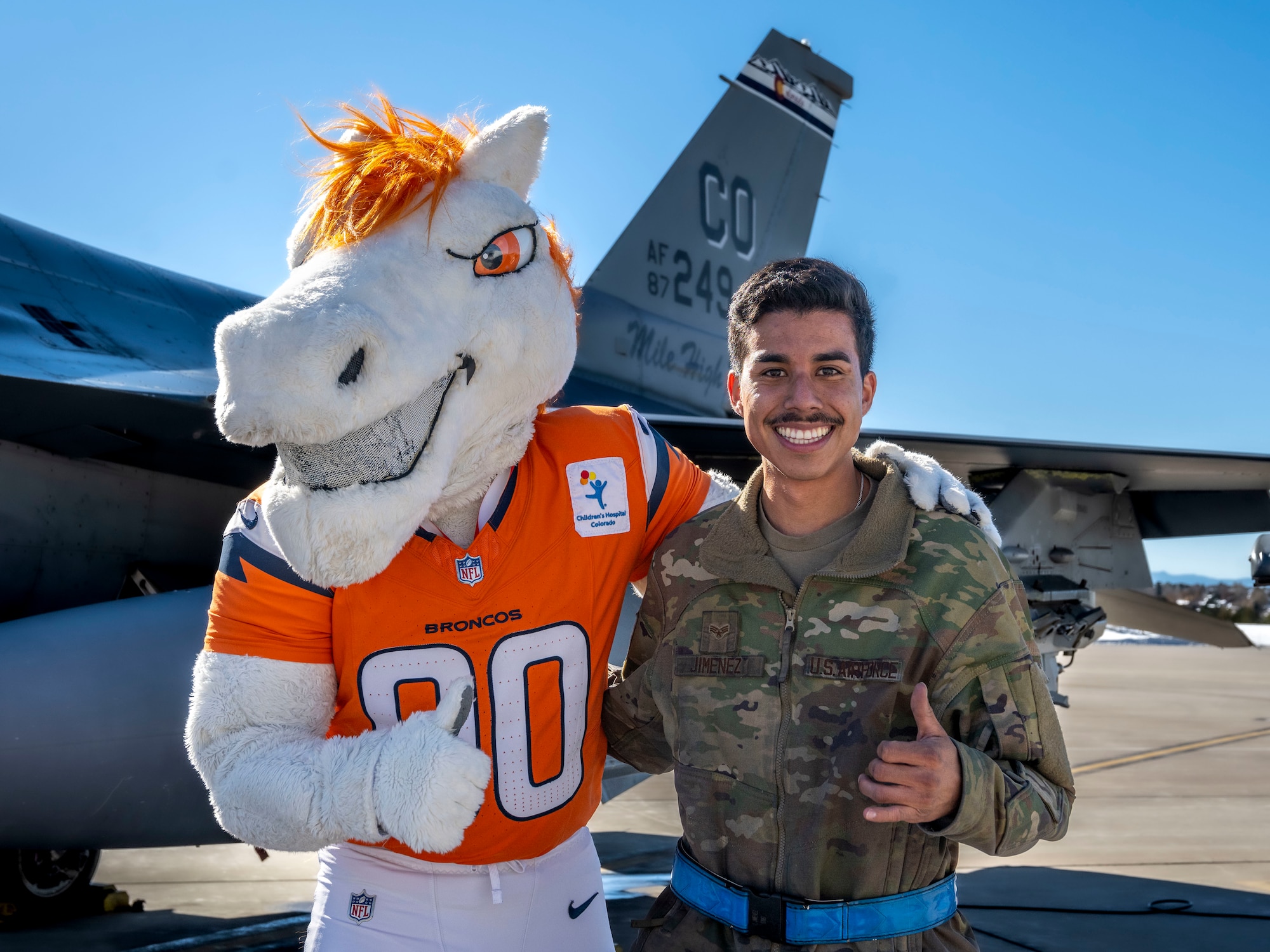 Denver Broncos' mascot Miles poses for a photo with U.S. Air Force Senior Airman Luis Jimenez, dedicated crew chief assigned to the 140th Maintenance Group, Buckley Space Force Base, Aurora, Colorado, Nov. 12, 2024.