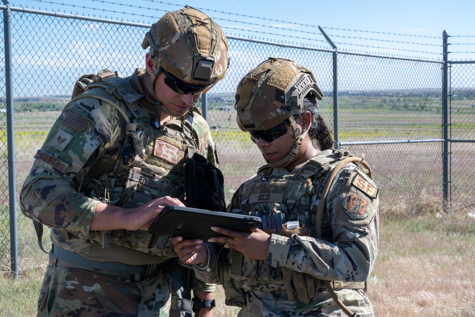 U.S. Air Force Airmen Basic D.J. Beckwith, left,  and Staff Sgt. Janayva Solis, right, 140th Security Forces Squadron, set up Helios, a mobile intrusion detection system, a rapidly deployable communication system and sensor, 140th Wing, Buckley Space Force Base, Aurora, Colo., June 7, 2024