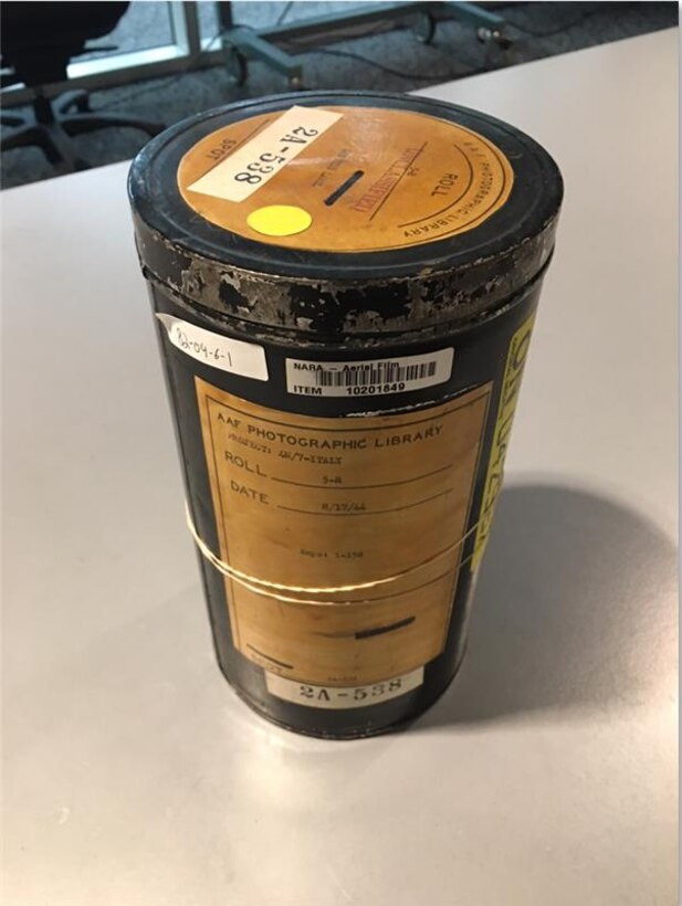 Geospatial analysts load a roll of film onto a light table on Dec.3, 2025.