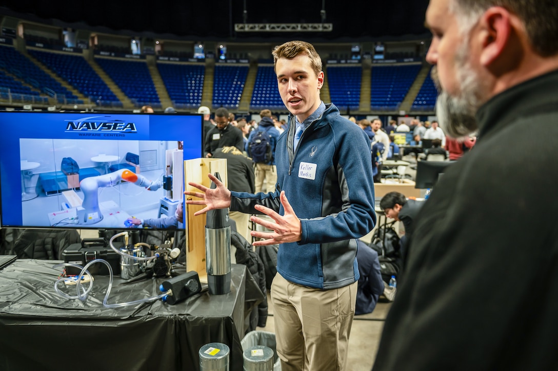 Keller Mardis, a senior electrical engineering student at Penn State, explains how the end-of-arm tool works when attached to a robotic arm. Mardis, along with four other students, developed the prototype as part of a Naval Surface Warfare Center Dahlgren Division-sponsored capstone project.