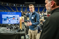 Keller Mardis, a senior electrical engineering student at Penn State, explains how the end-of-arm tool works when attached to a robotic arm. Mardis, along with four other students, developed the prototype as part of a Naval Surface Warfare Center Dahlgren Division-sponsored capstone project.