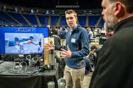 Keller Mardis, a senior electrical engineering student at Penn State, explains how the end-of-arm tool works when attached to a robotic arm. Mardis, along with four other students, developed the prototype as part of a Naval Surface Warfare Center Dahlgren Division-sponsored capstone project.