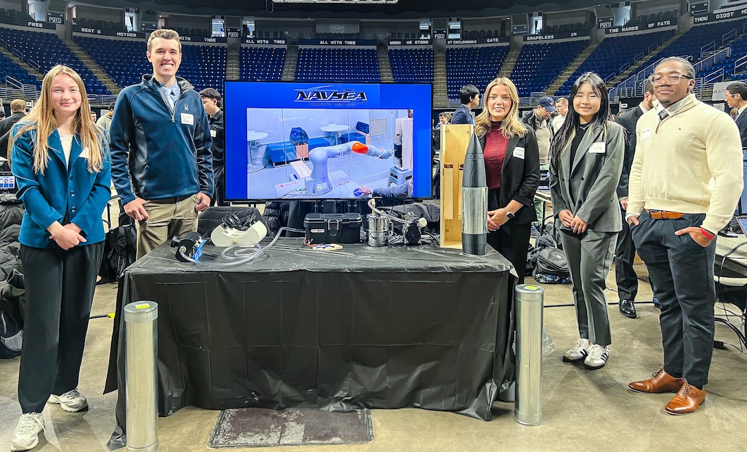 PENN STATE, Pa. – Penn State engineering students Victoria Walker, Keller Mardis, Lauren Hayden, Yixi Wang and Jackoy Gayle developed a custom end-of-arm tool prototype capable of picking up a Mark 45 5-inch round. Naval Surface Warfare Center Dahlgren Division sponsored the capstone project, which brought a fresh perspective to NSCWDD engineers working to make ammunition handling safer, faster and more sustainable for today’s fleet. (Provided photo)