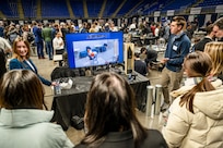 PENN STATE, Pa. – Penn State engineering students Keller Mardis and Victoria Walker talk about their custom end-of-arm tool during Capstone Project Showcase at Penn State College of Engineering’s Learning Factory on Dec. 11, 2025. The capstone project was sponsored by Naval Surface Warfare Center Dahlgren Division and won second place during the showcase. (Poornima Tomy/Penn State College of Engineering)