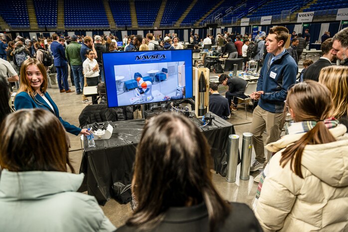 PENN STATE, Pa. – Penn State engineering students Keller Mardis and Victoria Walker talk about their custom end-of-arm tool during Capstone Project Showcase at Penn State College of Engineering’s Learning Factory on Dec. 11, 2025. The capstone project was sponsored by Naval Surface Warfare Center Dahlgren Division and won second place during the showcase. (Poornima Tomy/Penn State College of Engineering)