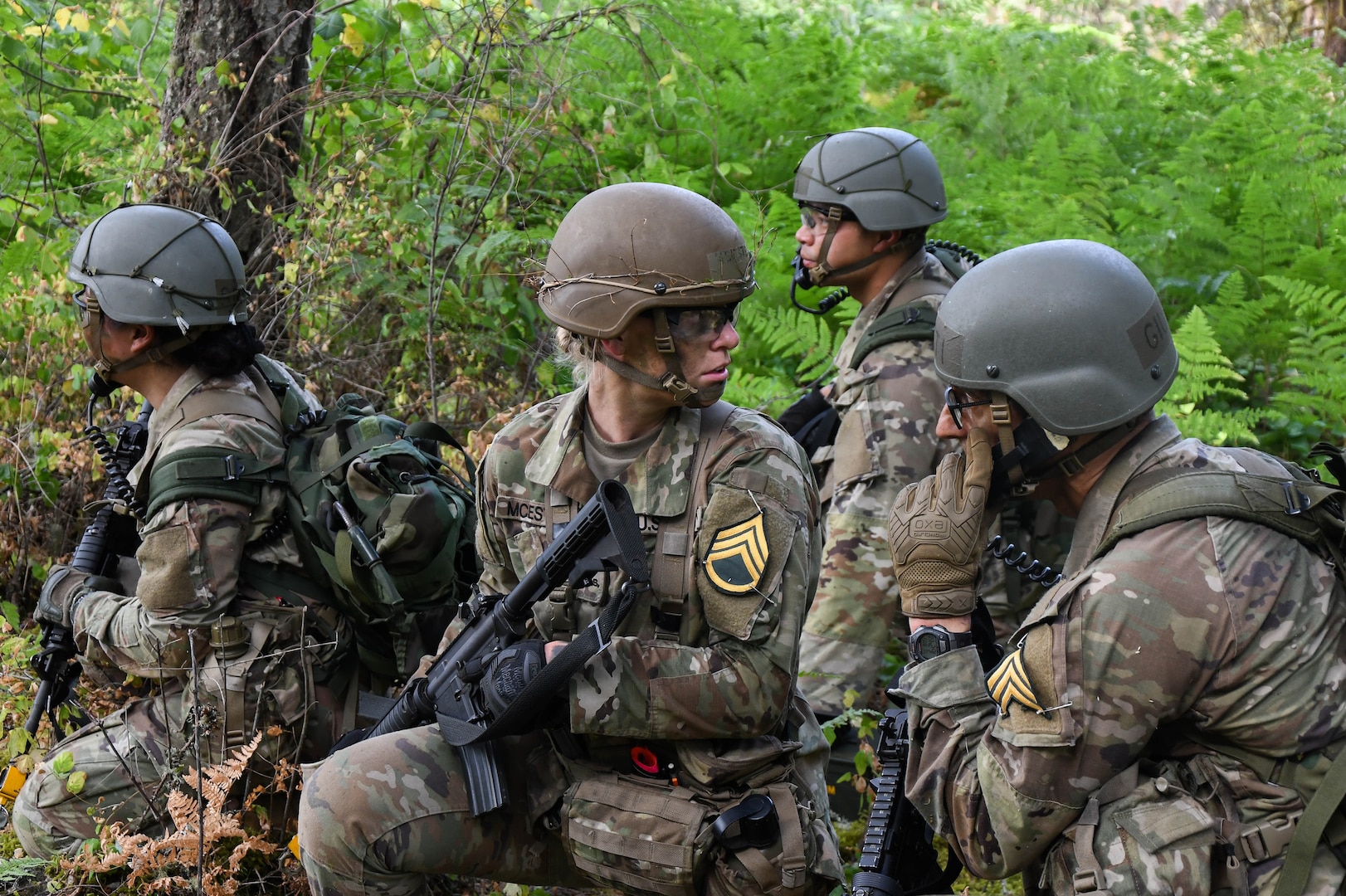 U.S. Army officer candidates listen on the radio for word from the platoon sergeant to advance their position while taking part in a platoon situational training exercise during Officer Candidate School, or OCS, Phase III at Joint Base Lewis-McChord, Wash., Aug. 5, 2025.