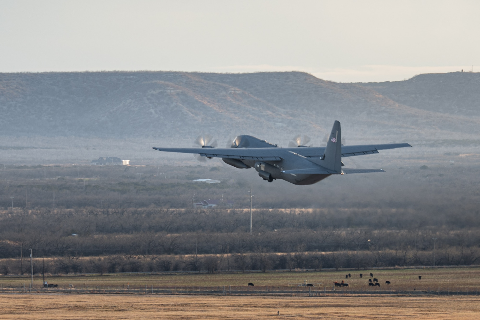 A U.S. Air Force C-130J Super Hercules equipped with external fuel tanks  assigned to the 317th Airlift Wing departs Dyess Air Force Base, Texas, Jan. 12, 2026, to execute a Maximum Endurance Operation in support of Exercise Palmetto Reach. This sortie marked the 317th AW’s 10th MEO into the Indo-Pacific region and allowed Airmen to replicate real-world challenges associated with compressed timelines and long-range tactical airlift. Exercise Palmetto Reach served as Joint Base Charleston’s Combat Readiness Exercise and validation event, designed to ensure forces can operate effectively in austere and contested environments. (U.S. Air Force photo by Senior Airman Jade M. Caldwell)