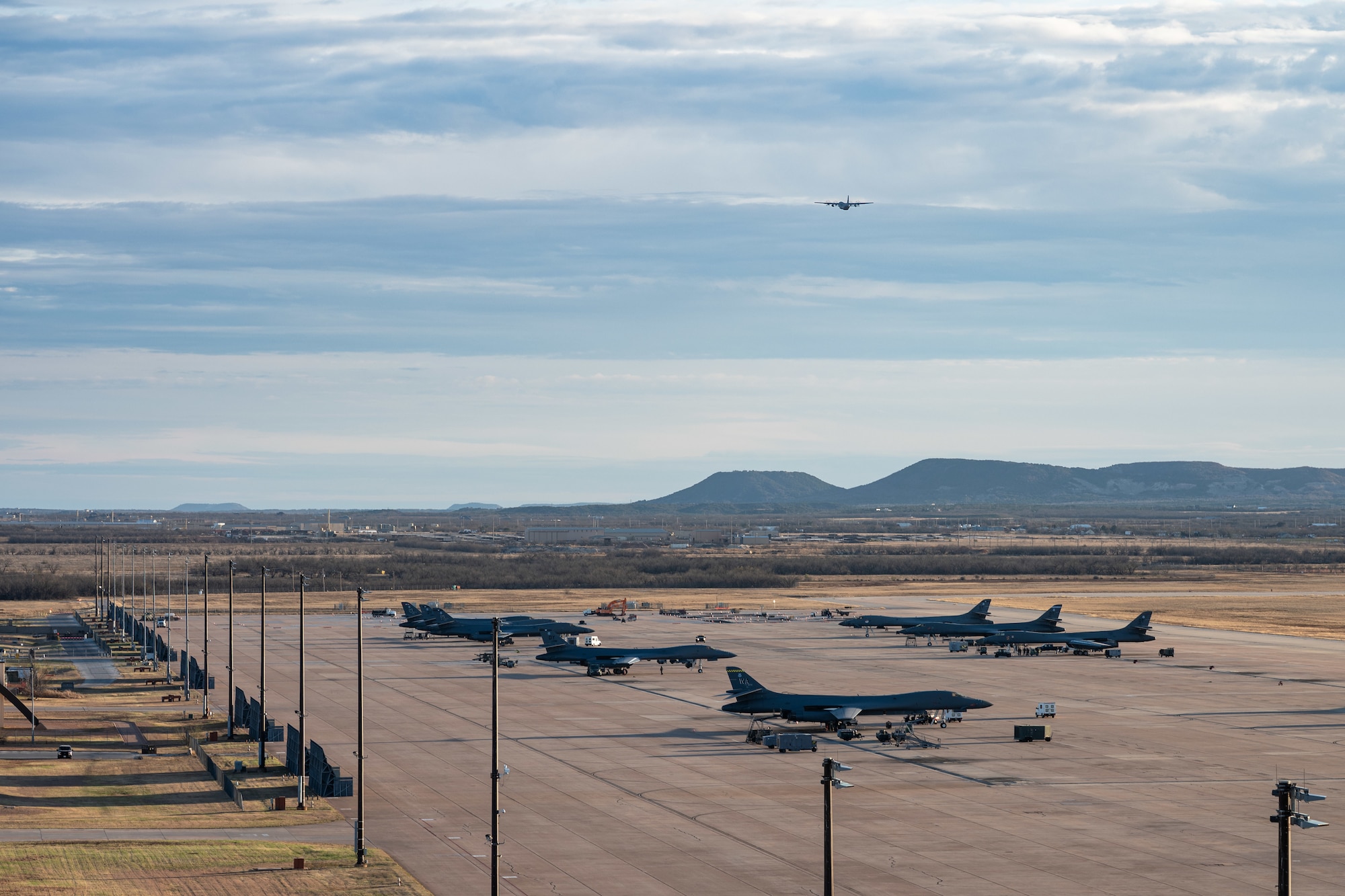 A U.S. Air Force C-130J Super Hercules equipped with external fuel tanks  assigned to the 317th Airlift Wing departs for a Maximum Endurance Operation at Dyess Air Force Base, Texas, Jan. 12, 2026. The mission marked the 317th Airlift Wing’s 10th MEO into the Indo-Pacific region, reducing warfighting timelines and extending tactical airlift reach (U.S. Air Force photo by Senior Airman Jade M. Caldwell)