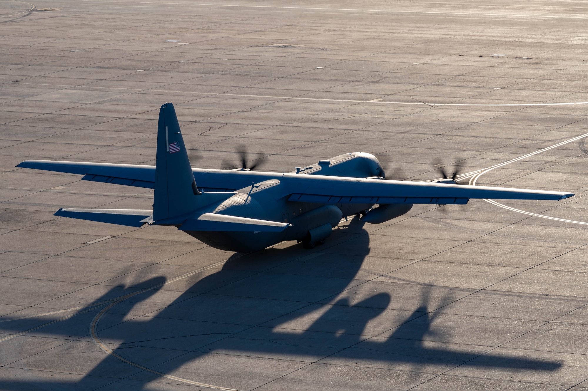 A U.S. Air Force C-130J Super Hercules equipped with external fuel tanks  assigned to the 317th Airlift Wing taxis before departing for a Maximum Endurance Operation at Dyess Air Force Base, Texas, Jan. 12, 2026. The mission marked the 317th AW’s 10th MEO into the Indo-Pacific region, extending tactical airlift reach by operating with minimal ground time and refueling stops. The 317th AW augmented Joint Base Charleston’s Combat Readiness Exercise with tactical airlift capabilities that enhanced interoperability and readiness for future Indo-Pacific operations. (U.S.  Air Force photo by Airman William Neal)