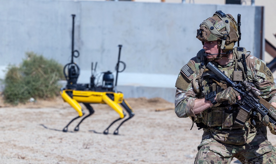 Soldier fights in tandem with various robotics in Human-Machine Integrated Formations during Project Convergence Capstone 5 experiment, March 15, 2025, at Fort Irwin, California