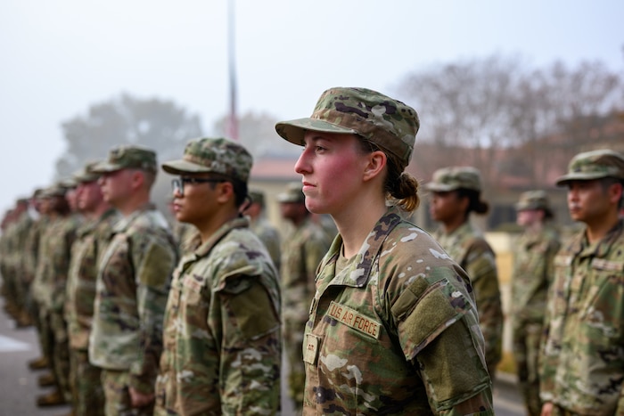 Female Air Force Servicemember poses in formation with others
