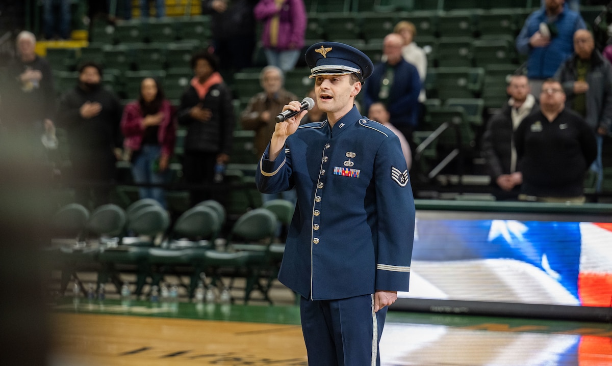 Staff Sgt. Marik Chrisman performs the national anthem prior to tip-off of the Wright State vs Youngstown State University Basketball game Jan. 15 at the Erwin J. Nutter Center. (U.S. Air Force photo by Jack Gardner)