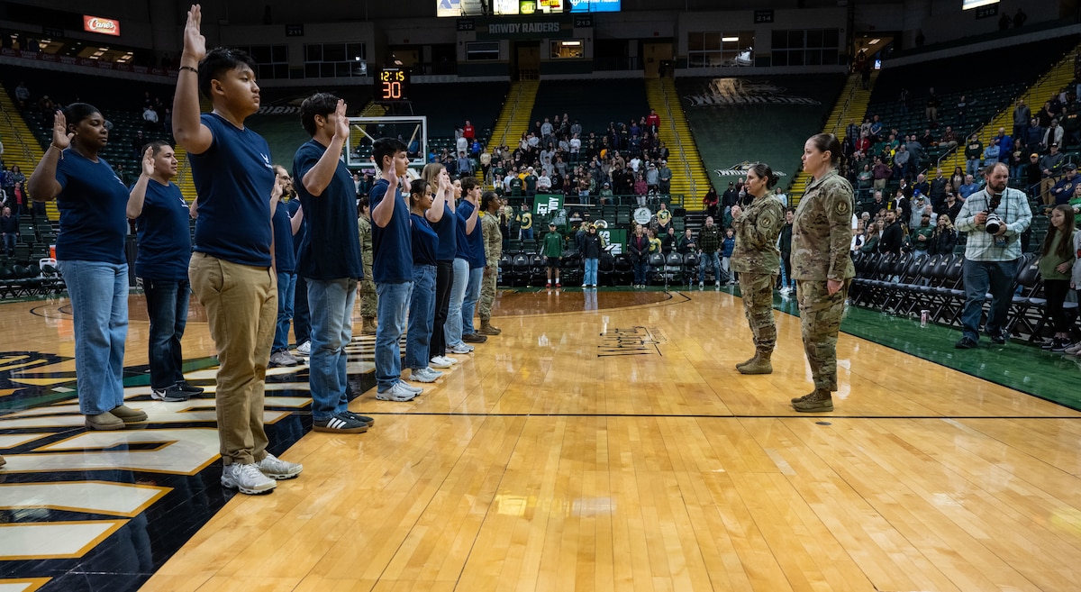 Col. Dorinda Mazza, 88th Air Base Wing Deputy Commander, and Chief Master Sgt. Tessa Fontaine, 88th Air Base Wing Command Chief administer the oath of enlistment to future Airmen during halftime of the Wright State vs Youngstown State University Basketball game Jan. 15 at the Erwin J. Nutter Center. (U.S. Air Force photo by Jack Gardner)