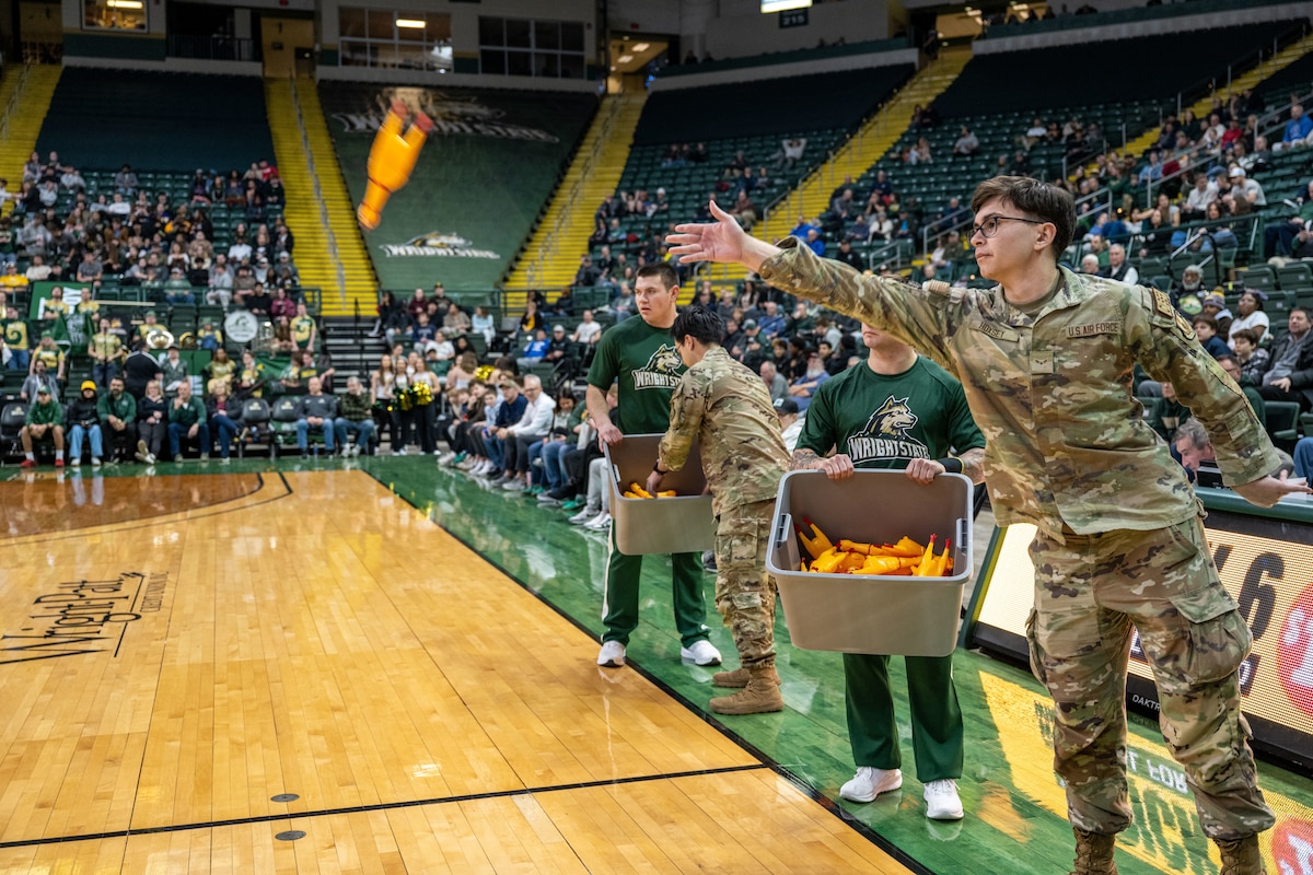 Airmen compete in a friendly game of chicken toss during halftime of the Wright State vs Youngstown State University Basketball game Jan. 15 at the Erwin J. Nutter Center. (U.S. Air Force photo by Jack Gardner)