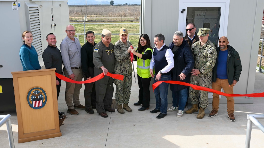 People cutting a ribbon at a ceremony for the Battery Energy Storage System at Defense Logistics Agency Distribution Sigonella, Italy.