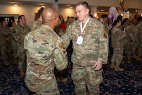 Senior Master Sgt. Philip Barry, Secretary of the Air Force Office of Special Trial Counsel, right, shakes hands with Chief Master Sgt. Anthony Thompson Jr., left, senior enlisted leader for Joint Base Anacostia-Bolling and the 11th Wing, command chief, during a chief master sergeant release party at JBAB, Washington, D.C., Jan. 15, 2026. Chief master sergeant, the highest enlisted rank, is held by just 1% of the Air Force's enlisted force. (U.S. Air Force photo by Hayden Hallman)