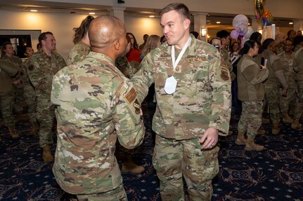 Senior Master Sgt. Philip Barry, Secretary of the Air Force Office of Special Trial Counsel, right, shakes hands with Chief Master Sgt. Anthony Thompson Jr., left, senior enlisted leader for Joint Base Anacostia-Bolling and the 11th Wing, command chief, during a chief master sergeant release party at JBAB, Washington, D.C., Jan. 15, 2026. Chief master sergeant, the highest enlisted rank, is held by just 1% of the Air Force's enlisted force. (U.S. Air Force photo by Hayden Hallman)