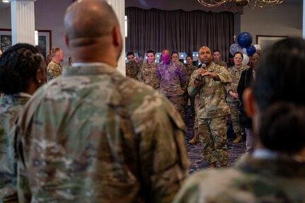 An audience member takes a photo of Senior Master Sgt. Juston Milliner, Office of Joint Chiefs of Staff, with colleagues during a chief master sergeant release party at Joint Base Anacostia-Bolling, Washington, D.C., Jan. 15, 2026. These individuals achieved the rank of chief master sergeant which is a mark of distinction, recognizing years of dedication and the ability to lead at the highest levels of the enlisted force. (U.S. Air Force photo by Hayden Hallman)