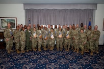 An audience member takes a photo of Senior Master Sgt. Juston Milliner, Office of Joint Chiefs of Staff, with colleagues during a chief master sergeant release party at Joint Base Anacostia-Bolling, Washington, D.C., Jan. 15, 2026. These individuals achieved the rank of chief master sergeant which is a mark of distinction, recognizing years of dedication and the ability to lead at the highest levels of the enlisted force. (U.S. Air Force photo by Hayden Hallman)