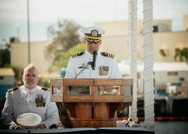 JOINT BASE PEARL HARBOR-HICKAM, Hawaii (Nov. 19, 2025) - Cmdr. Gieorag Andrews, outgoing commanding officer of Virginia-class fast-attack submarine USS Missouri (SSN 780), gives remarks during the change of command ceremony for Missouri at Joint Base Pearl Harbor-Hickam, Hawaii, Nov. 19, 2025. Missouri is assigned to Submarine Squadron 7 and is capable of supporting various missions, including anti-submarine warfare, anti-surface ship warfare, strike warfare, special operations forces support, and intelligence, surveillance, and reconnaissance. (U.S. Navy photo by Mass Communication Specialist 2nd Class Nicholas Russell)