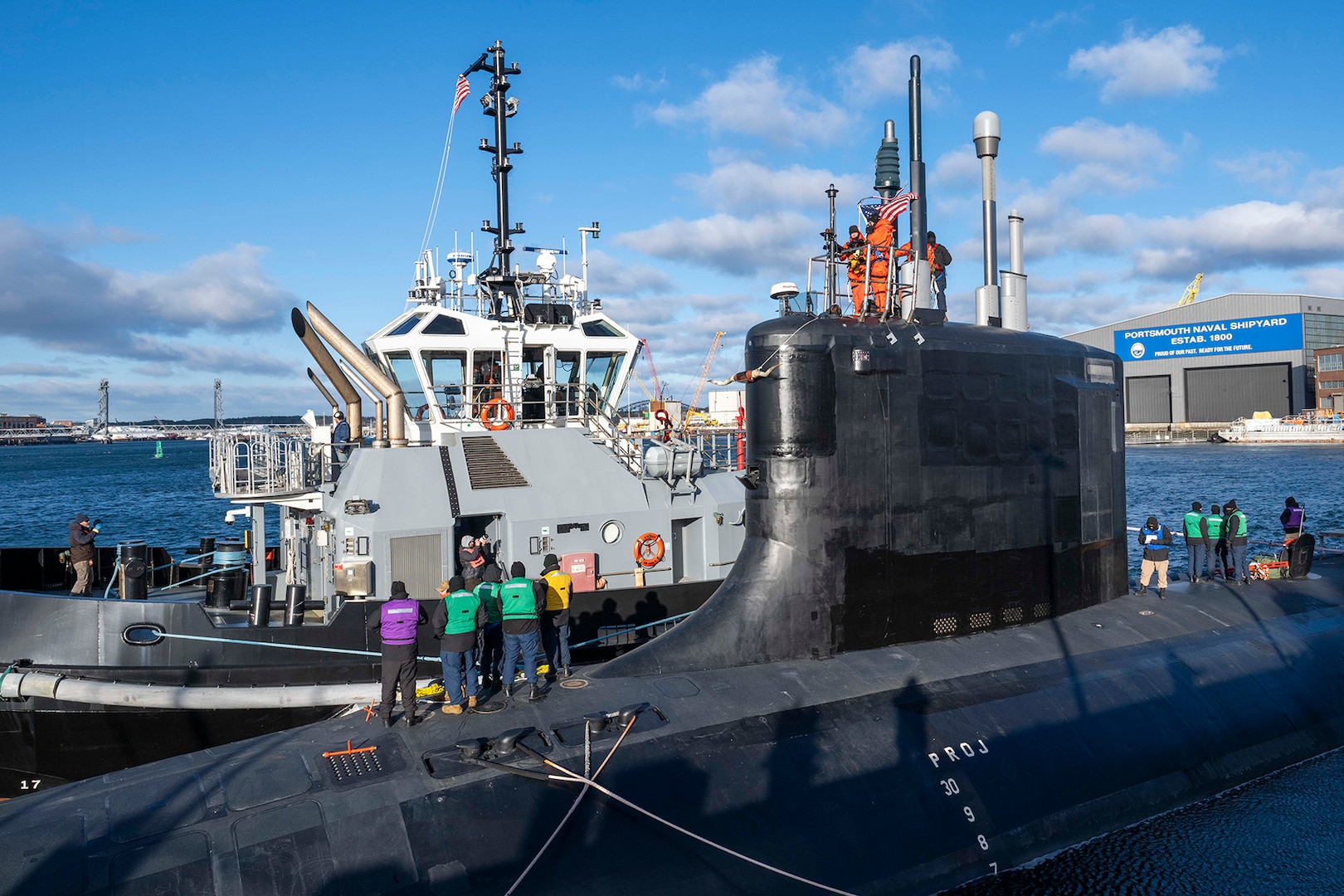 Sailors from the Virginia-class attack submarine USS Texas (SSN 775) pull in line from a tugboat as the submarine prepares to depart Portsmouth Naval Shipyard in Kittery, Maine, to conduct sea trials after receiving critical repairs and system upgrades vital to extending the submarine’s service life and ensuring the Navy’s long-term fleet readiness, Dec. 6, 2024.