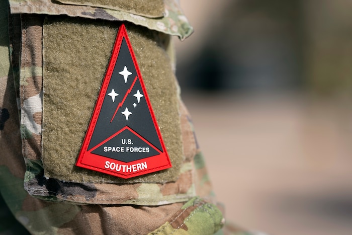 A U.S. Space Forces Southern patch is worn during an activation ceremony for Space Forces Southern at Davis-Monthan Air Force Base, Arizona, Jan. 21, 2026. SPACEFOR–SOUTH became operational effective Dec. 1, 2025, the ceremony formally recognized the activation with the assumption of command by Col. Brandon Alford, and the digital unveiling of the Space Forces Southern emblem, symbolizing the command’s mission and regional focus. (U.S. Air Force photo by Tech. Sgt. Rachel Maxwell)